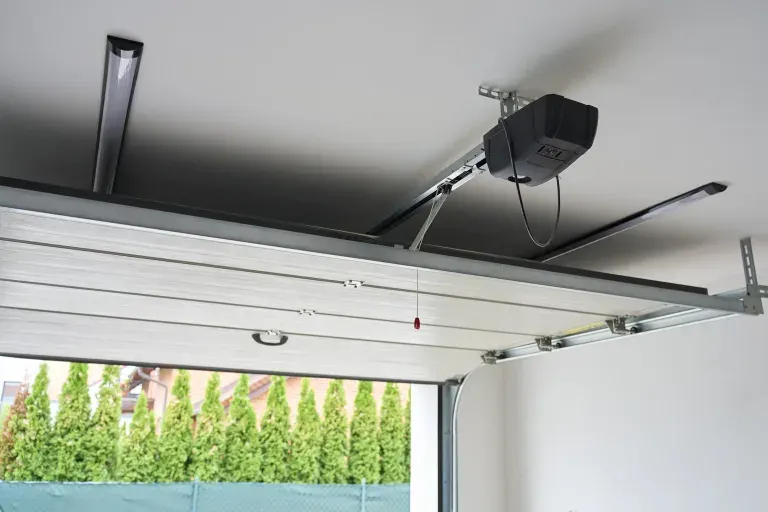 Garage door opener motor mounted on the ceiling