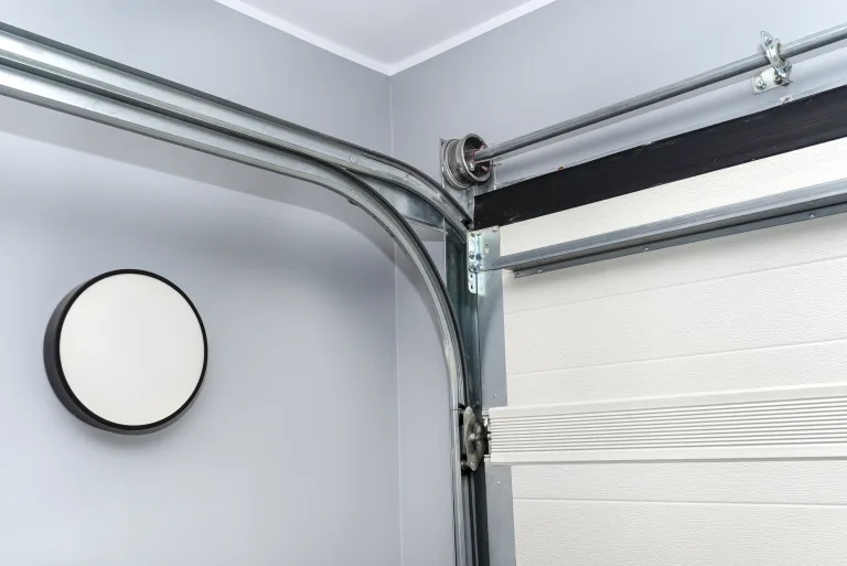 Cable drum and guide tracks of a residential garage door seen from inside