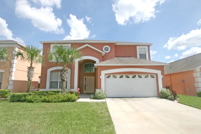 Sarasota home with a white garage door and stucco walls