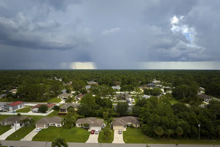 Dark storm clouds and rain moving over a suburban neighborhood